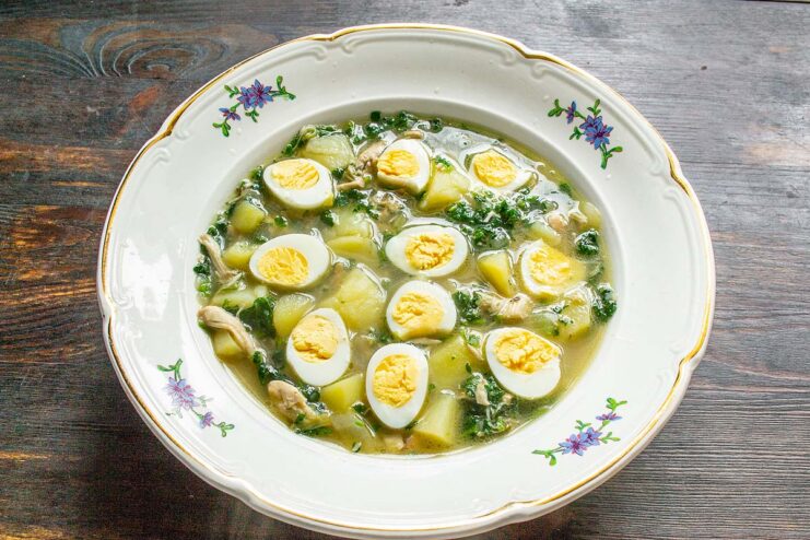 Serving the soup Serving freshly made nettle soup topped with quail egg halves