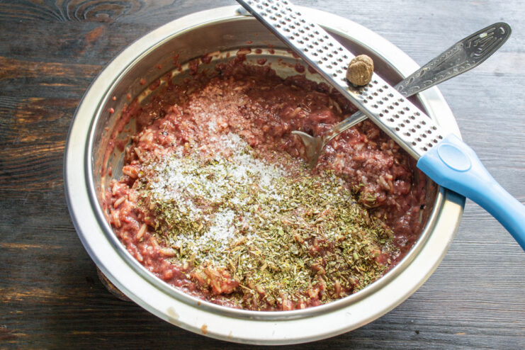 Adding Spices And Nutmeg Spices and freshly grated nutmeg being added to the liver mixture.