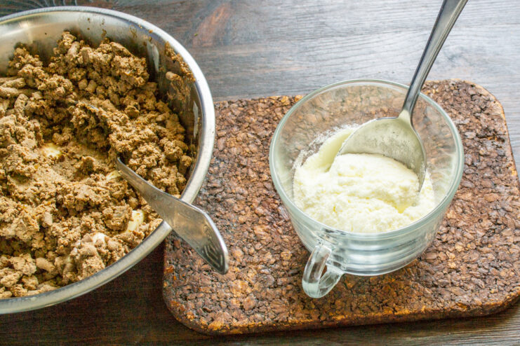 Preparing the powdered milk mixture Powdered milk with a spoon in a clear glass cup