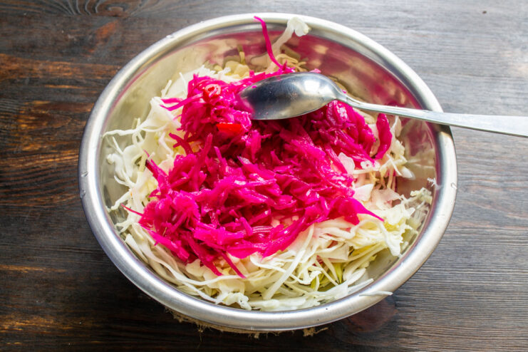Fresh green cabbage mixed with bright pink fermented beet sauerkraut.