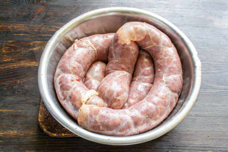 Raw Stuffed Sausage Raw liver sausage coiled in a bowl before cooking.