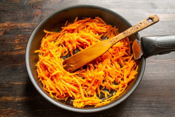 Sautéing Carrots Grated carrots sautéing in a skillet