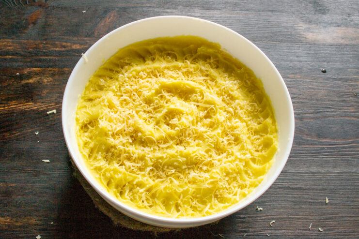 Adding Cheese Sprinkling grated cheese over mashed potatoes