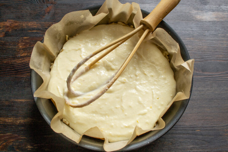 Liquid cheese filling poured evenly over the grated dough base