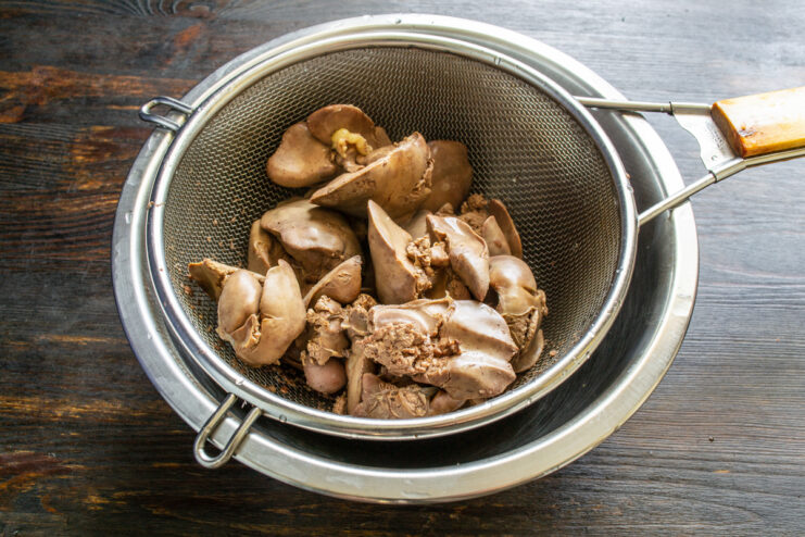 Draining boiled chicken livers Boiled chicken livers draining in a stainless steel colander