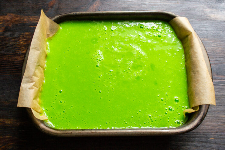 Setting the marmalade Green apple marmalade resting in a parchment-lined dish.
