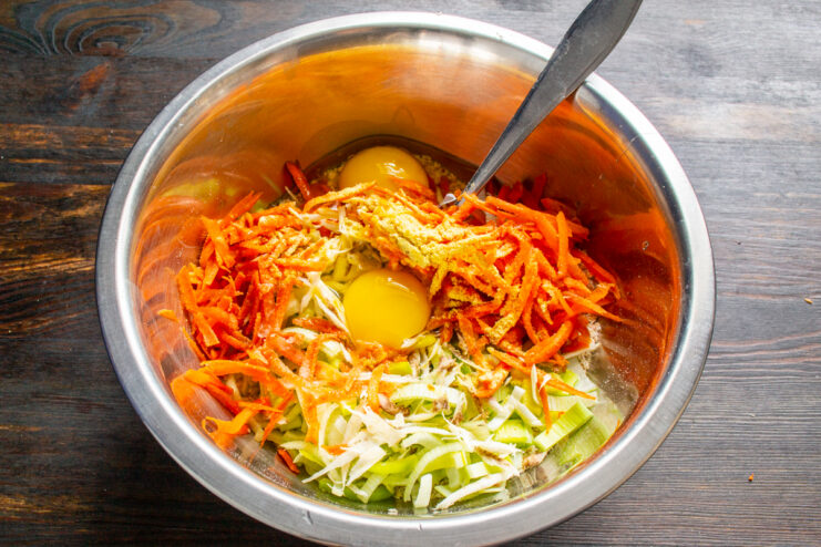 Eggs and olive oil in a bowl with the vegetable batter