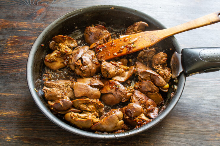 Glazed livers after wine reduction Pan-fried chicken livers with a rich wine glaze in a skillet