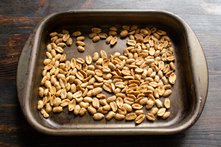 Roasting peanuts in the oven Golden roasted peanuts on a baking tray